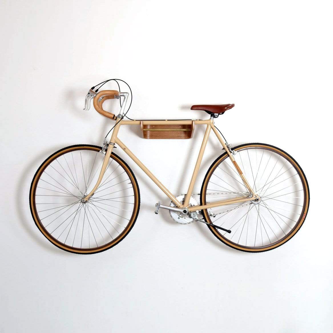 A bike hanging on a wooden bike hook on a wall
