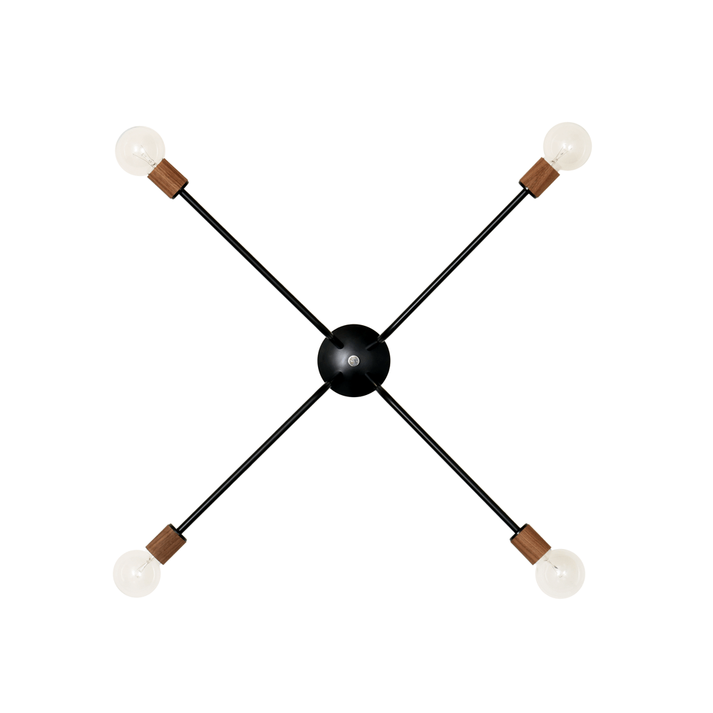 A modern chandelier with a black spherical center and four straight arms extending outward in a cross pattern, each ending with a brass-finished socket and a round white light bulb.
