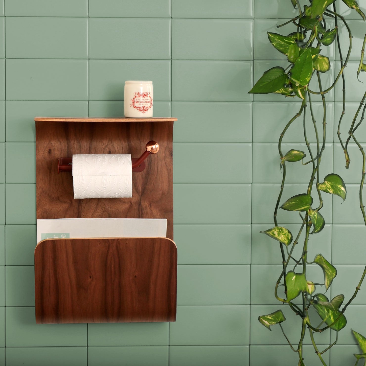 Walnut bathroom wall shelf on subway tile.