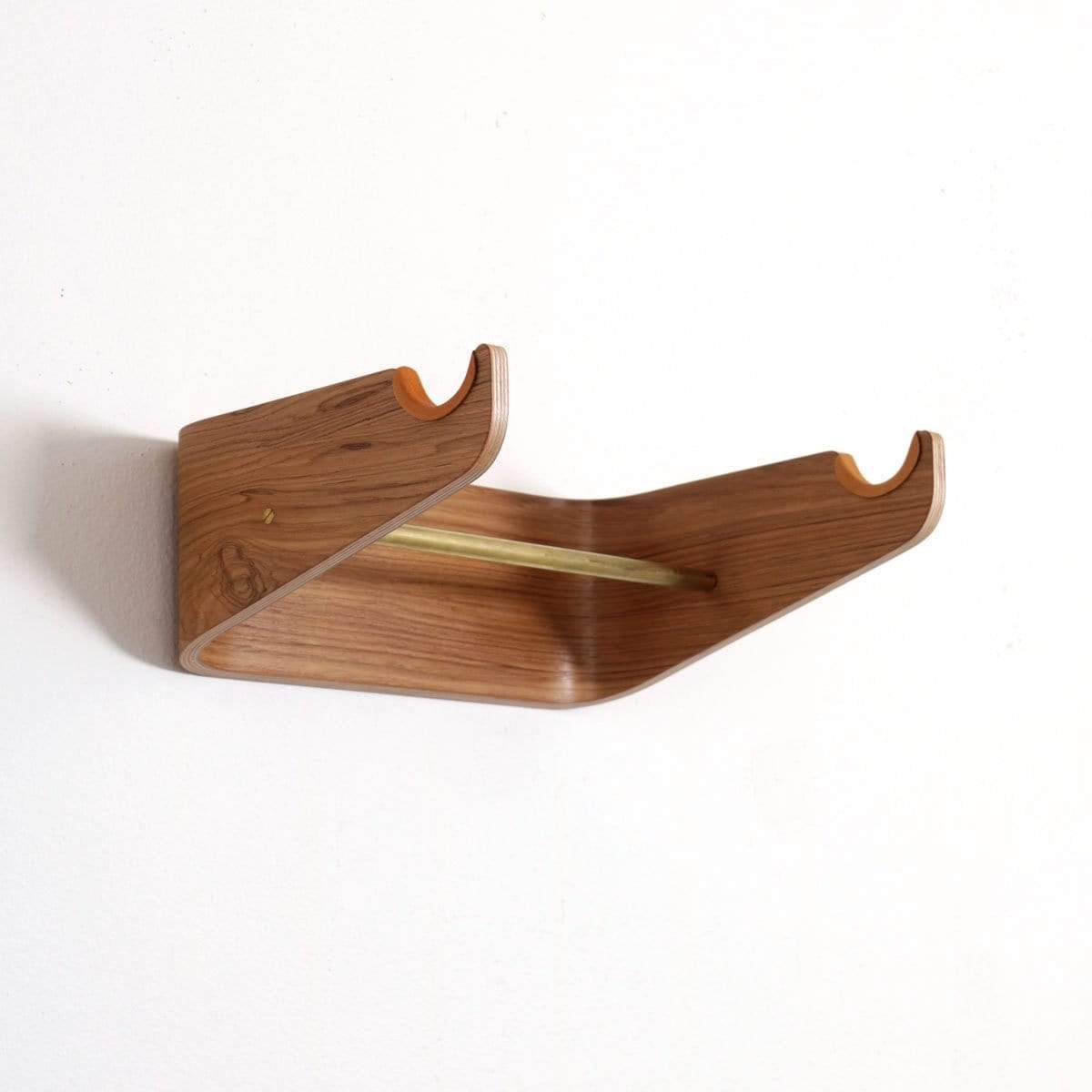 A bike hanging on a wooden bike hook on a wall
