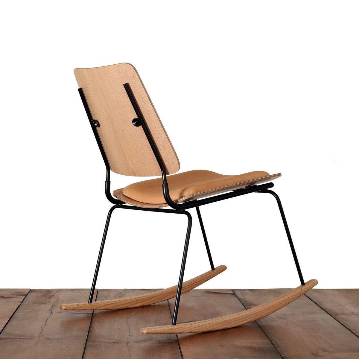 The back of a bent plywood chair rocking chair with no arms